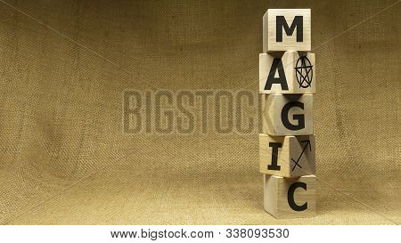 Wooden Cubes With Word Magic And Symbal On Sackloth Background. Business Concept