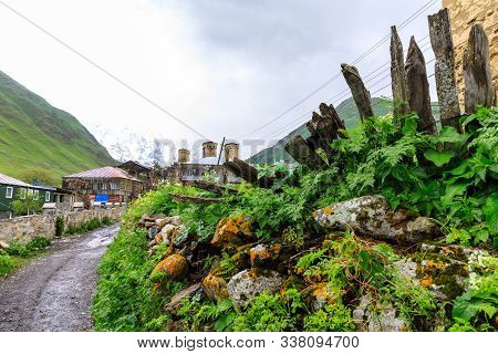 View Of The Ushguli Village At The Foot Of Mt. Shkhara. Lamaria Monastery, Rock Tower Towers And Old