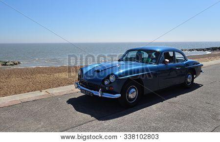 Felixstowe, Suffolk, England - May 06, 2018:  Classic Blue Jensen  Motor Car Being Driven Along Seaf