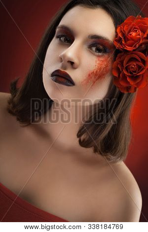 Beauty Womans Portrait. Evening Make-up On The Red Bokeh Background