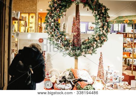 Strasbourg, France - Dec 20, 2016: Rear View Of Woman Admiring The Showcase Window Facade Of Villero
