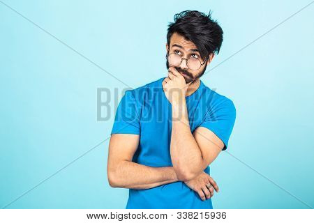 Emotional Portrait Of A Handsome Hindu Man In A Blue T-shirt On A Bright Blue Background, Think Abou