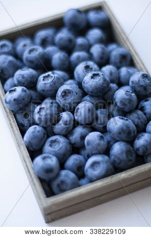 A Tasty And Healthy Snack: Juicy And Sweet Blueberries On Black Background