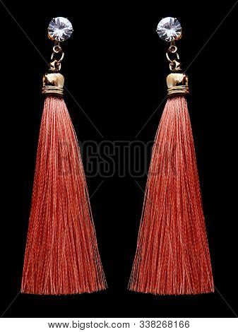 Red Tassel Earrings On A Black Background