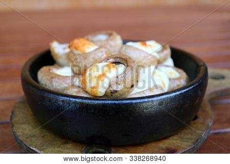 Closeup Soko Ketze Or Georgian Stuffed Mushrooms With Sulguni Cheese In A Clay Dish