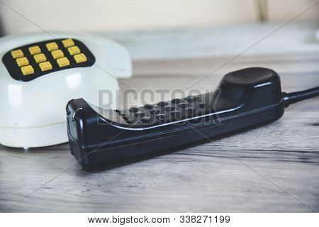 Vintage Phone On The Gtay Desk Background