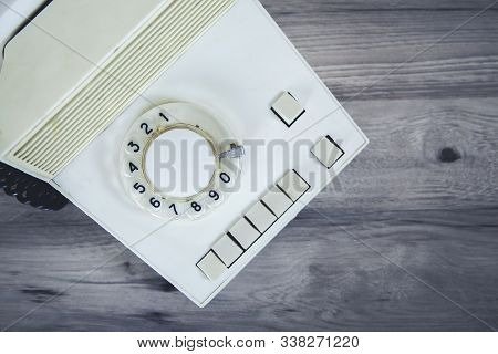 Vintage Phone On The Gtay Desk Background