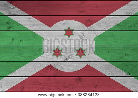 Burundi Flag Depicted In Bright Paint Colors On Old Wooden Wall. Textured Banner On Rough Background