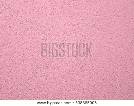 Textured wall painted pink. Surface with pink paint