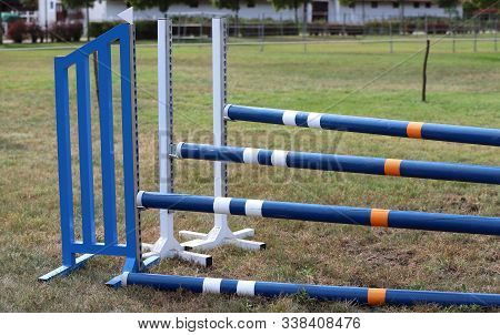 Image Of Show Jumping Poles On Empty Training Field. Wooden Barriers For Jumping Horses As A Backgro