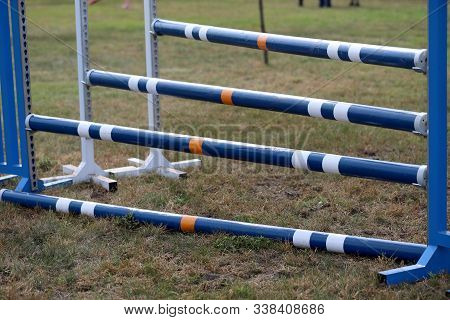 Image Of Show Jumping Poles On Empty Training Field. Wooden Barriers For Jumping Horses As A Backgro