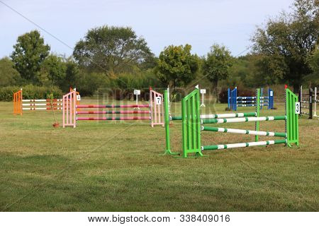 Image Of Show Jumping Poles On Empty Training Field. Wooden Barriers For Jumping Horses As A Backgro
