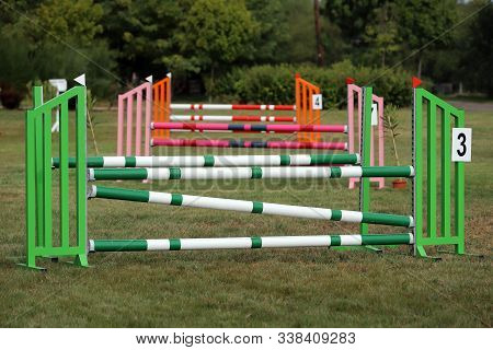 Image Of Show Jumping Poles On Empty Training Field. Wooden Barriers For Jumping Horses As A Backgro
