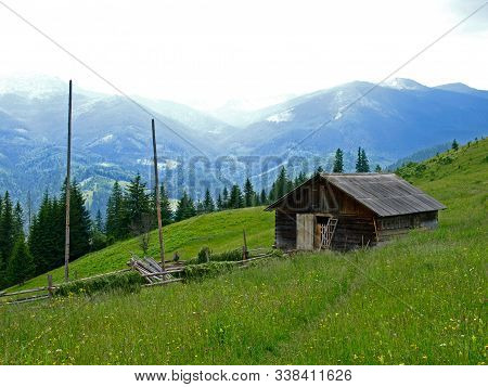 Household (farmer Barn) Or Hut High On The Meadow In Green Mountains. Picturesque Summer Mountain La
