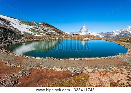 Riffelsee Lake And Matterhorn Mountain In The Alps, Located Between Switzerland And Italy