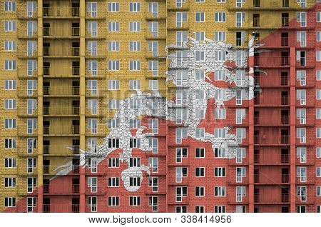 Bhutan Flag Depicted In Paint Colors On Multi-storey Residental Building Under Construction. Texture