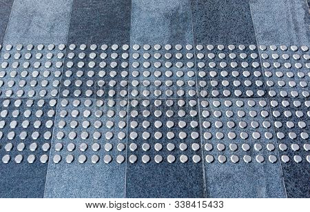Tactile Gray Tiles On The Sidewalk. Close Up. Metal Tactile Indicators