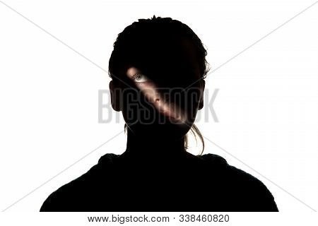 Dramatic Portrait Of Caucasian Young Girl In The Dark Isolated On White Studio Background. Sunlight 