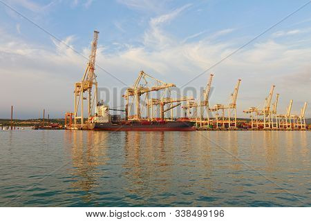 Piran, Slovenia-september 27, 2019:container Ship Loading By Containers. Harbor Of Koper With Many S