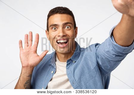Surprised And Impressed Man Didnt Expact See Someone As Holding Camera, Waving Hand In Hello Or Hi G