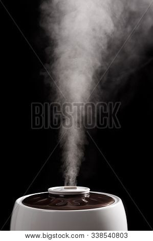 Ultrasonic Humidifier Releases Water Vapor From The Hole. On Black Background