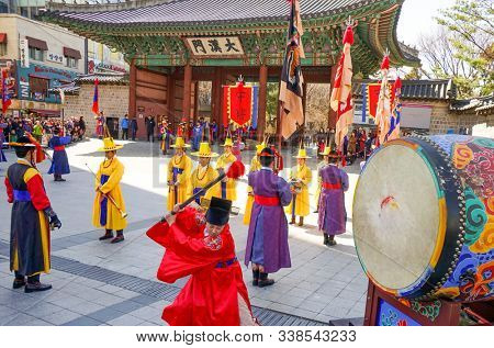 Seoul, March - 2019: Guard change ceremony at the Deoksugung Royal Palace. The drummer beats the big drum.