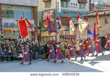 Seoul, March - 2019: Guard change ceremony at the Deoksugung Royal Palace. Procession with flags.
