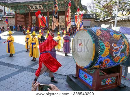 Seoul, March - 2019: Guard change ceremony at the Deoksugung Royal Palace. The drummer beats the big drum.