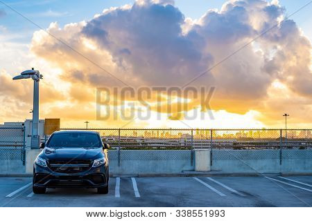 Miami, Florida - October 10 2017: Roof Top Parking Garage With Modern Black Vehicle Parked Facing Ou