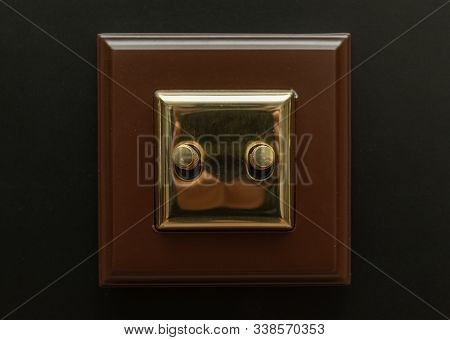 Two Golden Light Switch. Electric Switches. Two Electric Switches On A Wall