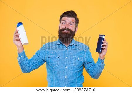 Bath Soap. Bath Cosmetics Review. Man Bearded Hipster Hold Plastic Bottles. Hair Care. Skin Lotion. 