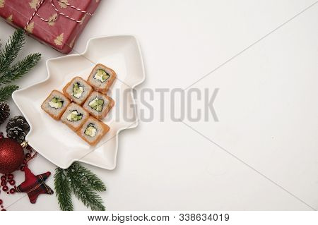 Sushi For Christmas Concept. Edible Christmas Tree Mde From Philadelphia Roll On White Background. F