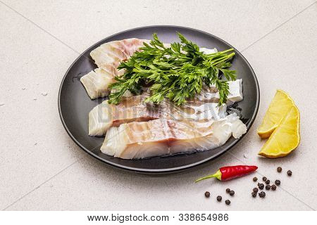 Raw Pollock (pollachius Virens) Pieces. Fresh Fish For Healthy Food Lifestyle. Lemon, Parsley, Sea S