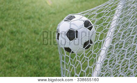 3d Illustration Soccer Ball Flew Into The Goal. Soccer Ball Bends The Net, Against The Background Of