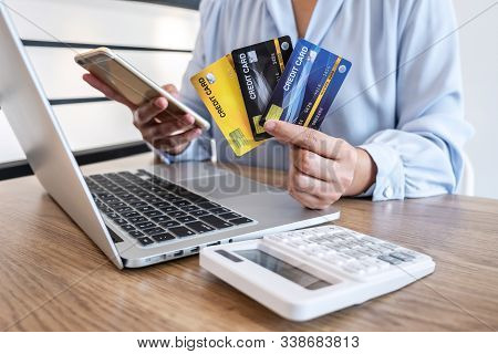 Businesswoman Using Smartphone, Laptop And Holding Credit Card For Paying Detail Page Display Online