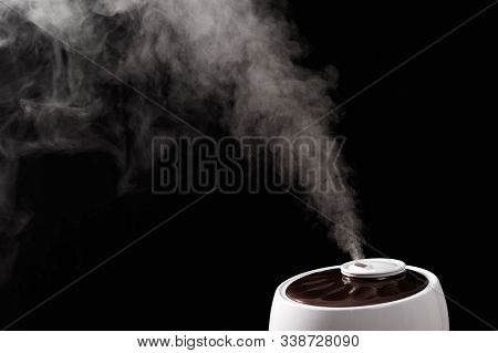 Ultrasonic Humidifier Releases Water Vapor From The Hole. On Black Background