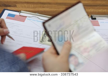 Close-up View Of Person Filling Usa Visa Application Form At Consulate. Official Paper To Entry Coun