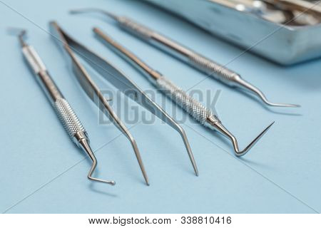 Set Of Metal Dental Instruments For Dental Treatment. Dental Plugger, Tweezers, Probe And Scraper On