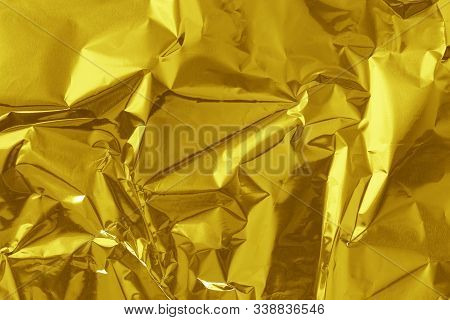 Gold Foil Leaf Shiny Texture, Abstract Yellow Wrapping Paper For Background And Design Art Work.