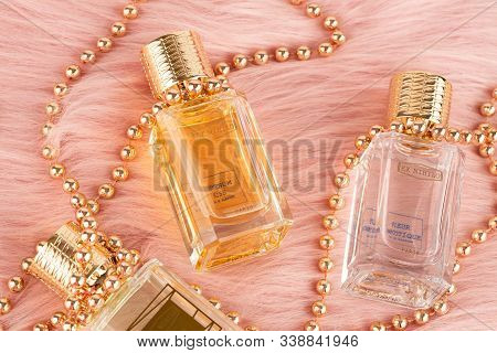 Limassol, Cyprus - August 1, 2019 - Three Bottles Of Ex Nihilo Perfume And Beads On Pink Fur Backgro
