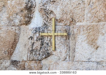 Ramla, Israel, December 07, 2019 : A Large Gilded Cross Hanging On The Wall On The Ruins Of A Byzant
