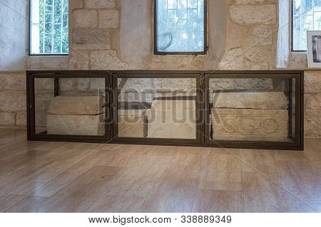 Ramla, Israel, December 07, 2019 : Several Sarcophagus In A Glass Case Stand In The Guest Room On Th
