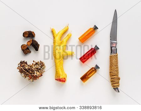 Raw Chicken Foot, Knife And Ampoules With Elixirs For Occult. Objects For Magic And Divination On A 