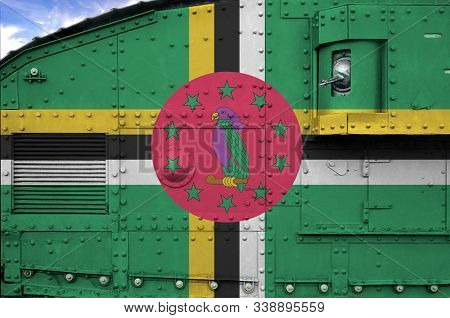 Dominica Flag Depicted On Side Part Of Military Armored Tank Closeup. Army Forces Conceptual Backgro