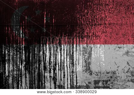 Singapore Flag Depicted In Paint Colors On Old And Dirty Oil Barrel Wall Closeup. Textured Banner On