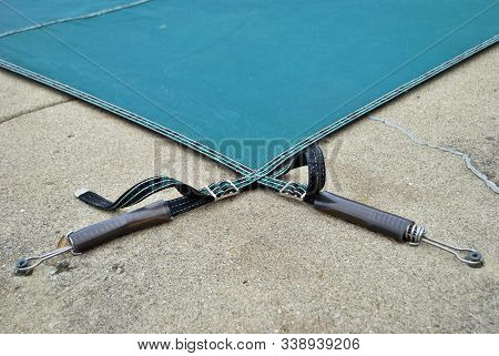 Backyard Swimming Pool With Diving Board And Pool Slide Tarped Up And Closed Down For Winter