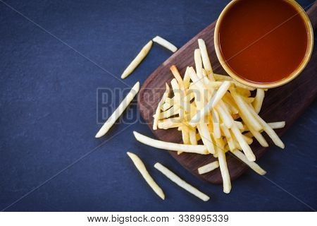 French Fries Ketchup In Wooden Board With Black Background / Tasty Potato Fries For Food Or Snack De