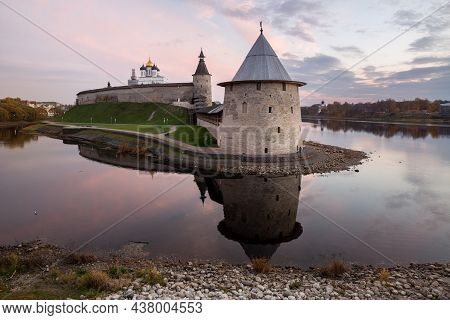 Scenic View Of The Pskov Kremlin At Sunset. Flat (ploskaya) Tower Is Reflected In The Water Of The P