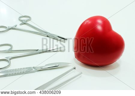 Heart And Surgical Instruments Isolated On The White Background