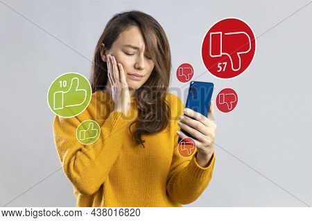 Young Sad Woman Feeling Unhappy And Desperate Holding Mobile Phone Looking More Dislikes Than Likes 